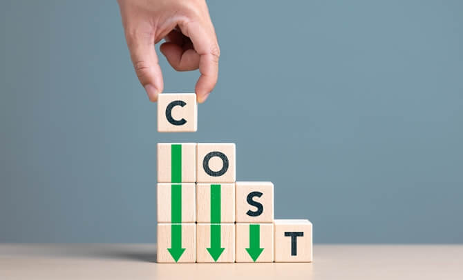 採用活動のコスト削減を示す積み木のイメージ。COSTの文字と下向き矢印で費用削減を表現。